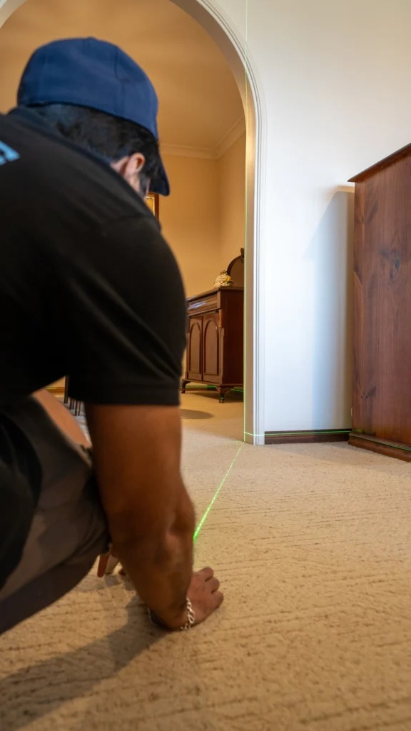 Inspector using a laser level to check floor levels