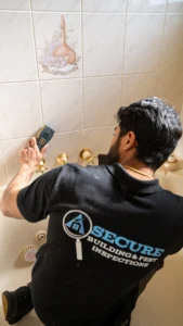 Moisture meter reading taken on bathroom wall tiles